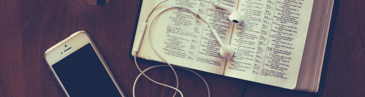 Bible with iPhone, earbuds and tea